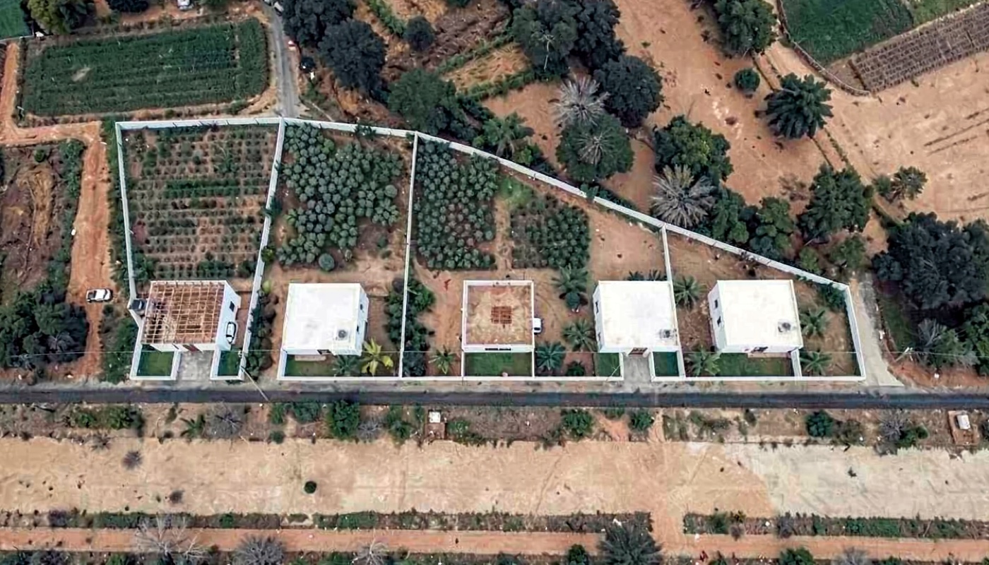 Top view of the real land with five homes in a row beside the canal road